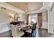 Inviting dining room with chandelier, hardwood floors, and beautiful table setting at 6770 Ulster Ct, Alpharetta, GA 30005