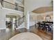 Open concept living area with hardwood floors, staircase, and views into the dining and living rooms at 6770 Ulster Ct, Alpharetta, GA 30005