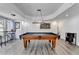 Basement game room showcases a pool table, bar stools by the window, and unique decor enhancing entertainment at 6770 Ulster Ct, Alpharetta, GA 30005