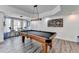 Entertaining game room with a pool table, bar seating, and light fixture perfect for friendly gatherings at 6770 Ulster Ct, Alpharetta, GA 30005