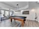 Recreational game room with a billiard table, overhead lighting, and hardwood floors ideal for entertaining guests at 6770 Ulster Ct, Alpharetta, GA 30005