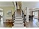 Grand staircase with hardwood floors and access to multiple rooms at 6770 Ulster Ct, Alpharetta, GA 30005