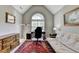 Bright home office with vaulted ceiling, desk, sofa, and ample natural light, creating a functional workspace at 6770 Ulster Ct, Alpharetta, GA 30005