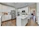 Kitchen with stainless steel appliances, white cabinets, hardwood floors and an eat-in island at 6770 Ulster Ct, Alpharetta, GA 30005