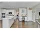 Spacious kitchen with white cabinets, stainless appliances, eat-in island, and custom built-in desk area at 6770 Ulster Ct, Alpharetta, GA 30005