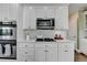 Gourmet kitchen with stainless steel appliances, gas range, and sleek white cabinetry at 6770 Ulster Ct, Alpharetta, GA 30005