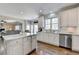 Open kitchen with island, stainless appliances, and hardwood flooring, perfect for entertaining at 6770 Ulster Ct, Alpharetta, GA 30005