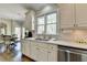 Kitchen with quartz counters, stainless appliances, and breakfast nook near wooded view at 6770 Ulster Ct, Alpharetta, GA 30005