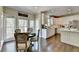 Bright kitchen with white cabinets, hardwood floors and an eat-in breakfast nook overlooking the backyard at 6770 Ulster Ct, Alpharetta, GA 30005