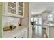 Bright kitchen with quartz counters and glass-front cabinets offers stylish storage solutions at 6770 Ulster Ct, Alpharetta, GA 30005