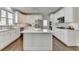 Well-lit kitchen with white cabinetry, a large kitchen island, stainless steel appliances, and hardwood floors at 6770 Ulster Ct, Alpharetta, GA 30005