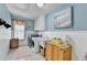 Efficient laundry room with blue walls, washer, dryer, utility sink, and storage, blending functionality with style at 6770 Ulster Ct, Alpharetta, GA 30005