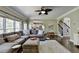 Relaxing living room featuring a ceiling fan, sofa, rug, and wood floors and open concept to the kitchen at 6770 Ulster Ct, Alpharetta, GA 30005