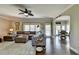 Bright and spacious living room with dark wood floors, ceiling fan, sofa, rug and natural light at 6770 Ulster Ct, Alpharetta, GA 30005