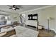 Inviting living room with hardwood floors, ceiling fan, sectional seating, and an open concept layout at 6770 Ulster Ct, Alpharetta, GA 30005