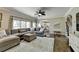 Cozy living room featuring a sectional sofa, rug, fireplace, ceiling fan and an open layout at 6770 Ulster Ct, Alpharetta, GA 30005