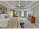 Spacious main bedroom featuring trey ceilings, neutral carpet and an ensuite bathroom at 6770 Ulster Ct, Alpharetta, GA 30005