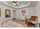 Charming main bedroom with carpet, sitting chair, and view of an ensuite at 6770 Ulster Ct, Alpharetta, GA 30005