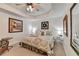 Cozy main bedroom featuring a tray ceiling, carpet, and decorative accents at 6770 Ulster Ct, Alpharetta, GA 30005