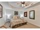 Inviting main bedroom with tray ceiling, neutral carpet, and decorative wall art at 6770 Ulster Ct, Alpharetta, GA 30005