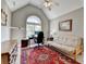 Bright office space features vaulted ceilings, a large window, and a comfortable seating area with a couch at 6770 Ulster Ct, Alpharetta, GA 30005