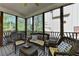 Screened porch with comfortable wicker furniture and views of backyard at 6770 Ulster Ct, Alpharetta, GA 30005