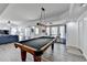 Spacious recreation room with hardwood floors, a pool table, and plenty of natural light for entertaining at 6770 Ulster Ct, Alpharetta, GA 30005