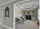Sitting room with a fireplace, custom shelves, large windows, and view to primary bedroom at 6770 Ulster Ct, Alpharetta, GA 30005