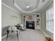 Sitting room offers a black fireplace, custom shelves, and comfortable seating near large windows at 6770 Ulster Ct, Alpharetta, GA 30005