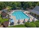 Large community pool area with lounge chairs, umbrellas, and tables at 6770 Ulster Ct, Alpharetta, GA 30005