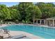 Sparkling pool surrounded by lounge chairs and lush greenery, ideal for relaxation at 6770 Ulster Ct, Alpharetta, GA 30005