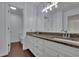 Stylish bathroom featuring granite counters, double sinks, modern fixtures, and white cabinets at 9415 Martin Rd, Roswell, GA 30076