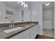 Stylish bathroom featuring granite counters, double sinks, modern fixtures, and white cabinets at 9415 Martin Rd, Roswell, GA 30076
