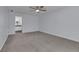 Spacious bedroom with neutral carpet, a ceiling fan, and an ensuite bathroom at 9415 Martin Rd, Roswell, GA 30076