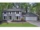 Charming two-story home with gray brick exterior and well-manicured front lawn at 9415 Martin Rd, Roswell, GA 30076