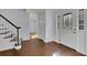 Inviting foyer with hardwood floors, staircase, and decorative glass front door at 9415 Martin Rd, Roswell, GA 30076