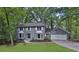 Charming gray home with well-maintained lawn and a two car garage at 9415 Martin Rd, Roswell, GA 30076