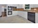 Modern kitchen with stainless steel appliances and a tiled backsplash at 9415 Martin Rd, Roswell, GA 30076