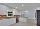 Bright kitchen with white cabinets, granite countertops, and modern pendant lighting at 9415 Martin Rd, Roswell, GA 30076