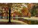Picturesque autumn landscape showcasing vibrant trees reflected in the calm lake at 9415 Martin Rd, Roswell, GA 30076