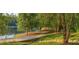 Scenic view of a lakeside walkway, featuring a stone bridge and lush green surroundings at 9415 Martin Rd, Roswell, GA 30076