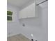 Clean laundry room with white cabinetry and a window at 9415 Martin Rd, Roswell, GA 30076