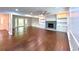 Spacious living room with hardwood floors, fireplace, built-ins, and a large bay window at 9415 Martin Rd, Roswell, GA 30076
