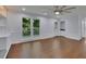 Open living room with hardwood floors, fireplace, and an adjacent sunroom/deck at 9415 Martin Rd, Roswell, GA 30076