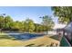 Wide view of tennis courts with lake in background at 9415 Martin Rd, Roswell, GA 30076