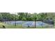 Well-maintained tennis courts surrounded by lush greenery, offering recreational opportunities for residents at 9415 Martin Rd, Roswell, GA 30076