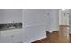 A convenient wet bar features granite counters, white cabinets, and stainless faucet at 9415 Martin Rd, Roswell, GA 30076