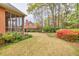 Backyard featuring mature landscaping and a brick home with a screened in porch at 2330 Burlington Ln, Snellville, GA 30078