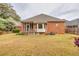 Backyard featuring a brick home with a screened in porch and flowering bushes at 2330 Burlington Ln, Snellville, GA 30078