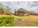 Backyard featuring a brick home with screened porch, and mature flowering bushes at 2330 Burlington Ln, Snellville, GA 30078